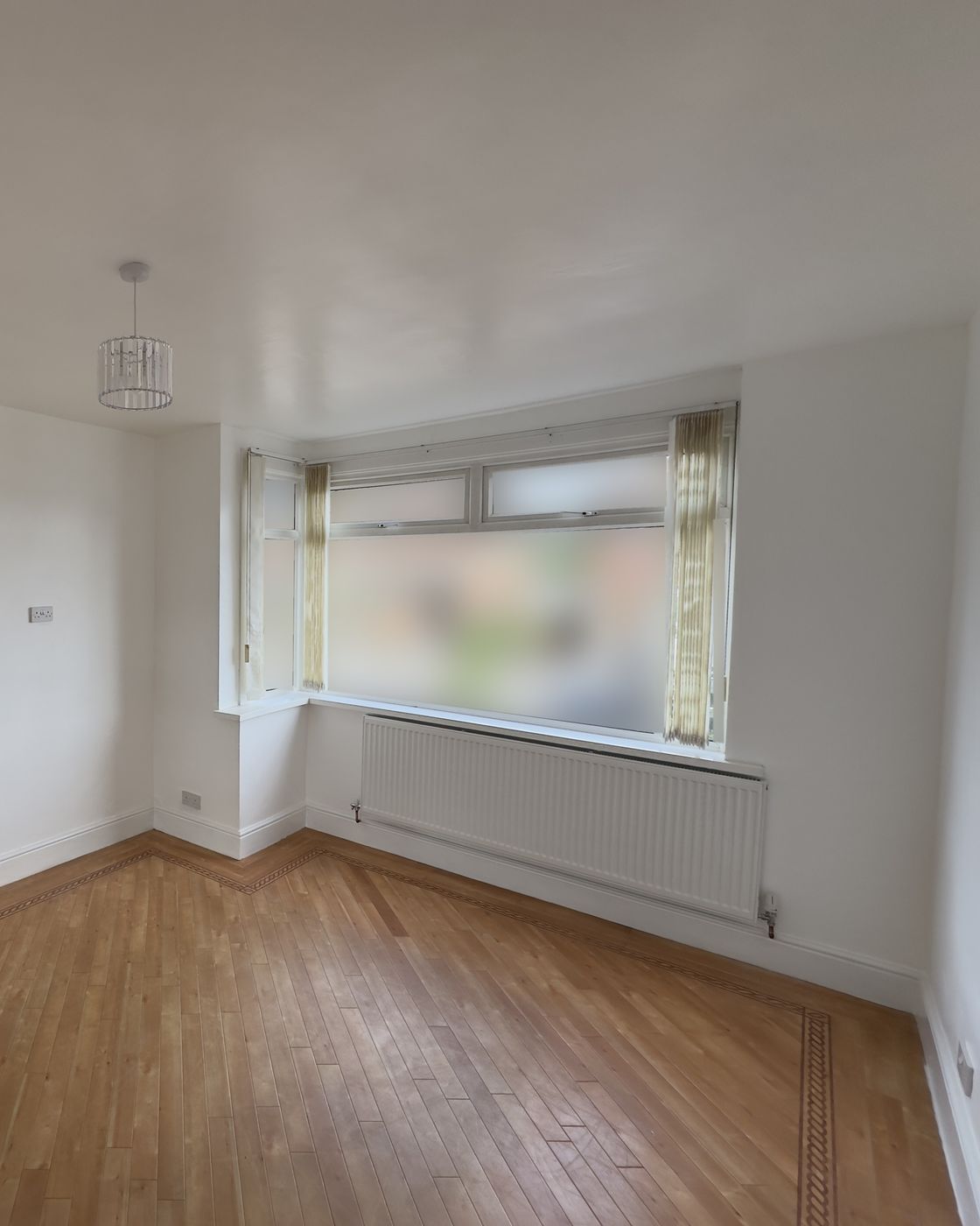 Lounge bay window after, walls refinished, parquet kept