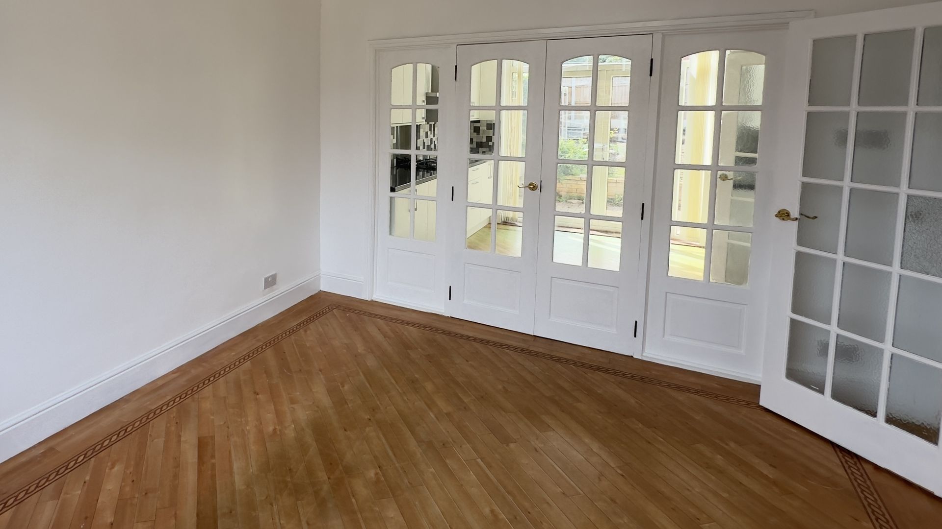 Lounge after, same view through the double doors to the French doors